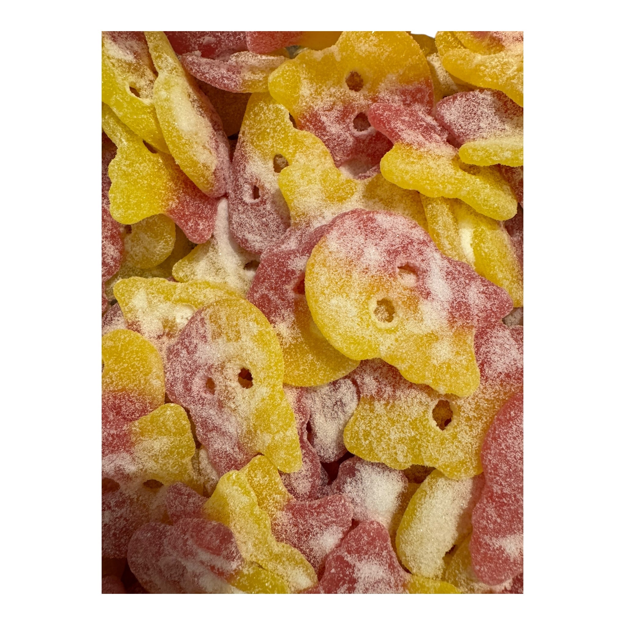Close-up of colorful gummy candy shaped like skulls on a white background