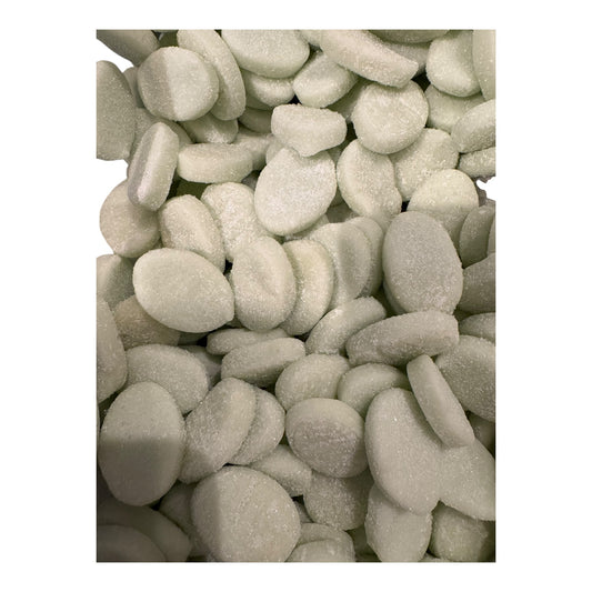 Close-up of light green candies on a white background