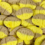 Yellow and gray oval-shaped cookies with a brand logo on a pile.