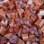 Close-up of hard candy with intricate designs on a pile