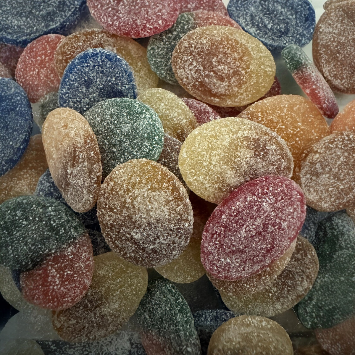 Close-up of colorful gummy candy with a sugary texture.