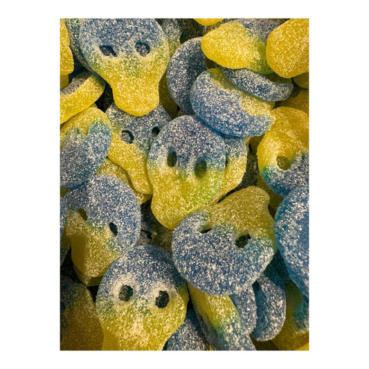 Gummy skulls in blue and yellow with a white background